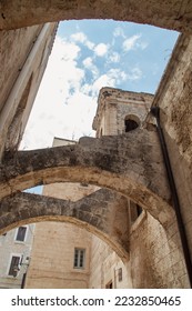 Chiesa SS. Pietro e Paolo (Church of Saint Peter and Saint Paul in Italian) in Monopoli, Italy. Flying buttresses of the church in Largo Palmieri alley. - Shutterstock ID 2232850465