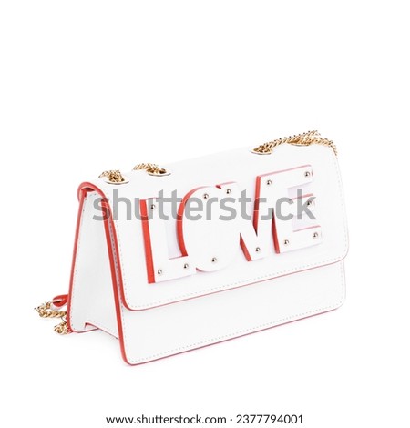 Chik female bag from white leather with red trim and a gold shoulder chain, decorated with the cut-out word 