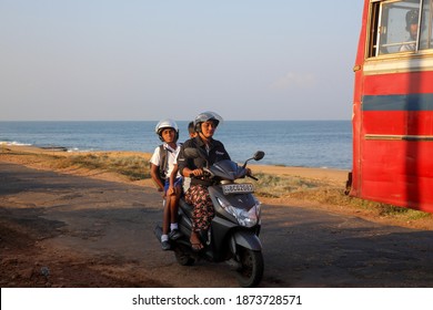 Chilaw, Sri Lanka-March 26, 2019: Sri Lankan Mother And School Going Kids Riding On A Scooty At Chilaw, Sri Lanka. 