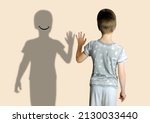 child 8-10 years old in gray t-shirt extended his hand to his shadow, concept imaginary friend, problems of loneliness, self-knowledge, psychology of childhood, personality development of teenager