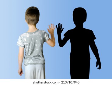 Child 8-10 Years Old In Gray T-shirt Extended His Hand To His Shadow, Concept Imaginary Friend, Problems Of Loneliness, Self-knowledge, Psychology Of Childhood, Personality Development Of Teenager