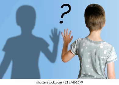 Child 8-10 Years Old In Gray T-shirt Extended His Hand To His Shadow, Concept Imaginary Friend, Problems Of Loneliness, Self-knowledge, Psychology Of Childhood, Personality Development Of Teenager