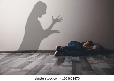 Child Abuse. Mother Yelling At Her Daughter. Shadow Of Woman On Wall