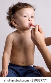 The Child Accepts A Medicine (syrup) For Temperature.