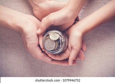 child and adult holding money jar, donation, saving, charity, family finance plan concept, Coronavirus economic stimulus rescue package, superannuation concept