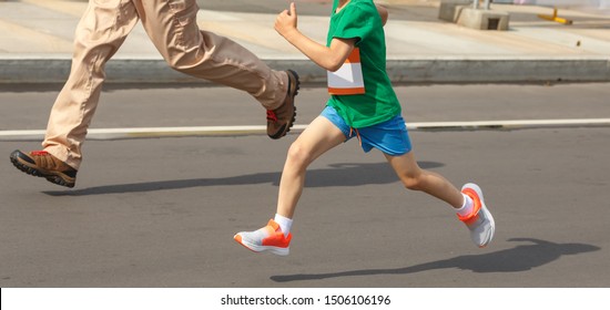 Child And Adult Run On Distillation. Feet Running People