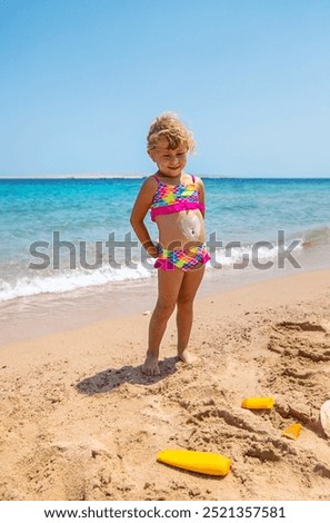 Child applying sunscreen. Selective focus Kid