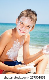 Child Applys Too Much Of Sunblock Cream