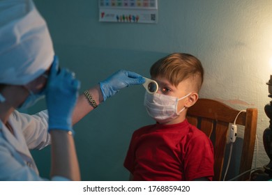 Child At Appointment With An Optometrist. Doctor Woman Checks The Boy's Eyesight. City Hospital. May, 2020, Brovary, Ukraine.