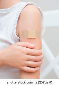 Child Arm With An Adhesive Bandage.