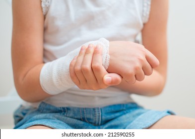 Child Arm With Gauze Bandage On It.