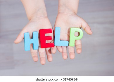 The Child Asks For Help. Written Help Letters On The Palms