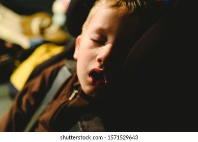 Child Asleep In His Extenuated Car Seat.