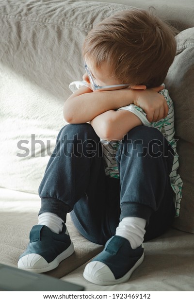 Child Autism Glasses Sits On Sofa Stock Photo (Edit Now) 1923469142