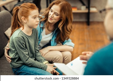 Child With Autism. Nice Sad Girl Looking In Front Of Her While Suffering From Autism