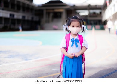 Child Back To School Concept. Girl Wearing Cloth Face Mask. Kid Shoulder Pink Bag. Children Wearing Student Uniform. Baby Aged 3-4 Year Old.