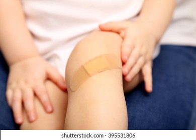 Child With Band Aid On Knee 