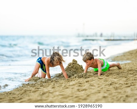 Similar – Two kids digging on the beach