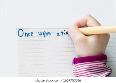 Child Begins A Story With Once Upon A Time; Child Starts A Story And Prints With A Pen