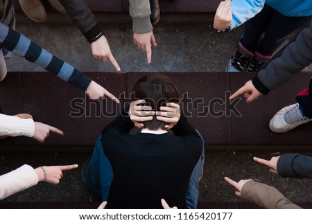 A child being bullied by a group of children. bullying scene 