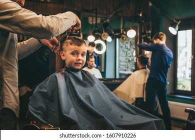 The child is being cut hairstyles in the hairdressing salon - Powered by Shutterstock