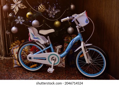 Child bicycle as present under Christmas tree.
