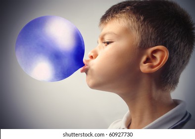 Child Blowing A Blue Bubble Gum