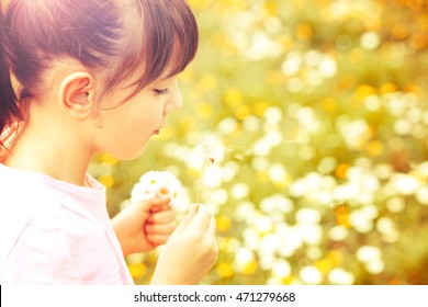 Child Blowing Dandelion