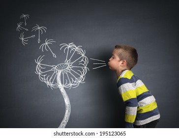 Child Blowing Dandelion Seeds On A Blackboard Concept For Wishing, Hope And Aspirations