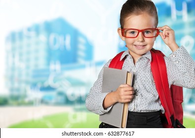 Child with book and backpack.
