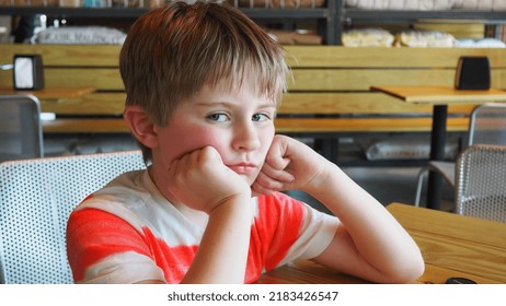 Child Bored And Screen Free In A Restaurant