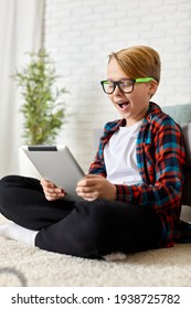 Child Boy In Checkered Shirt Using Digital Tablet