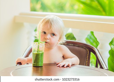 Child boy drinking healthy green vegetable smoothie - healthy eating, vegan, vegetarian, organic food and drink concept. - Powered by Shutterstock