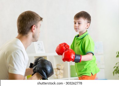 Child Boy And His Dad Play Boxing In Nursery