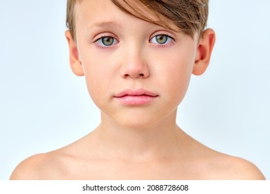 Child Boy In The Morning, Shirtless Sad Kid Looking At Camera, After Waking Up, Standing With Calm Facial Expression. Children, Lifestyle Concept. Isolated White Background