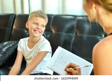 Child Boy On The Interview. Educational Courses For Children. Home Schooling. Of Joyful Learning. Boy Does Testing. Home Tutor