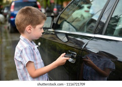 Child Boy Open The Car Door With Car Key