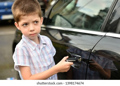 Child Boy Open The Car Door With Car Key