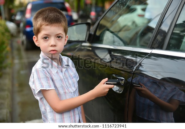 child boy open the car\
door with car key