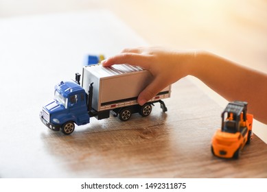 Child Boy Playing Toys On Table At Home / Kid Hands Playing Toy Car Truck 