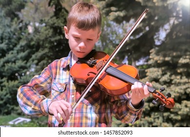 Child Boy Is Playing The Violin Standing In Park In The City. Portrait Of Little Musician. Education Learn Play Violin Boy Teen Violinist Instrumentalist Performance Melody.