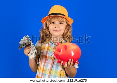 Child boy putting in piggy bank usd dollar banknotes. Business, saving and economic.