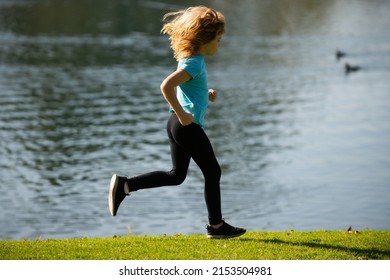 Child Boy Running Outdoors. Kid Running In A Summer Park.