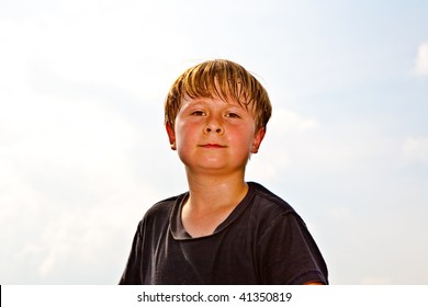 child boy is smiling, happy and sweating in the face  after doing sport