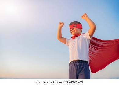 Child Boy In A Superhero Costume With A Red Cape