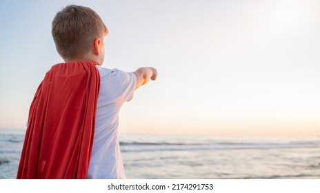 Child Boy In A Superhero Costume With A Red Cape