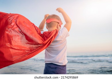 Child Boy In A Superhero Costume With A Red Cape