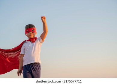 Child Boy In A Superhero Costume With A Red Cape