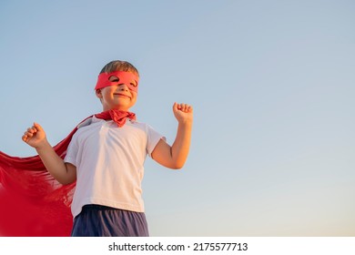 Child Boy In A Superhero Costume With A Red Cape