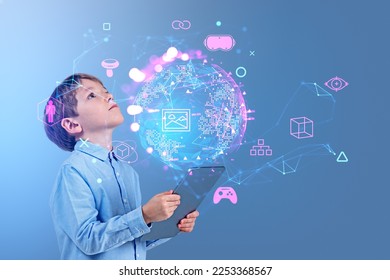 Child boy with tablet in hands, look up at earth sphere hologram with glowing icons. Virtual reality connection hud hologram, nft and online games. Concept of metaverse and technology - Shutterstock ID 2253368567